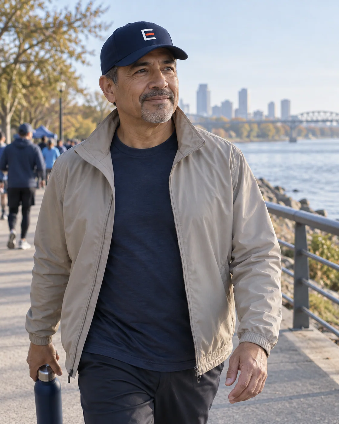 A person wearing a subtly embroidered E-marked cap outdoors